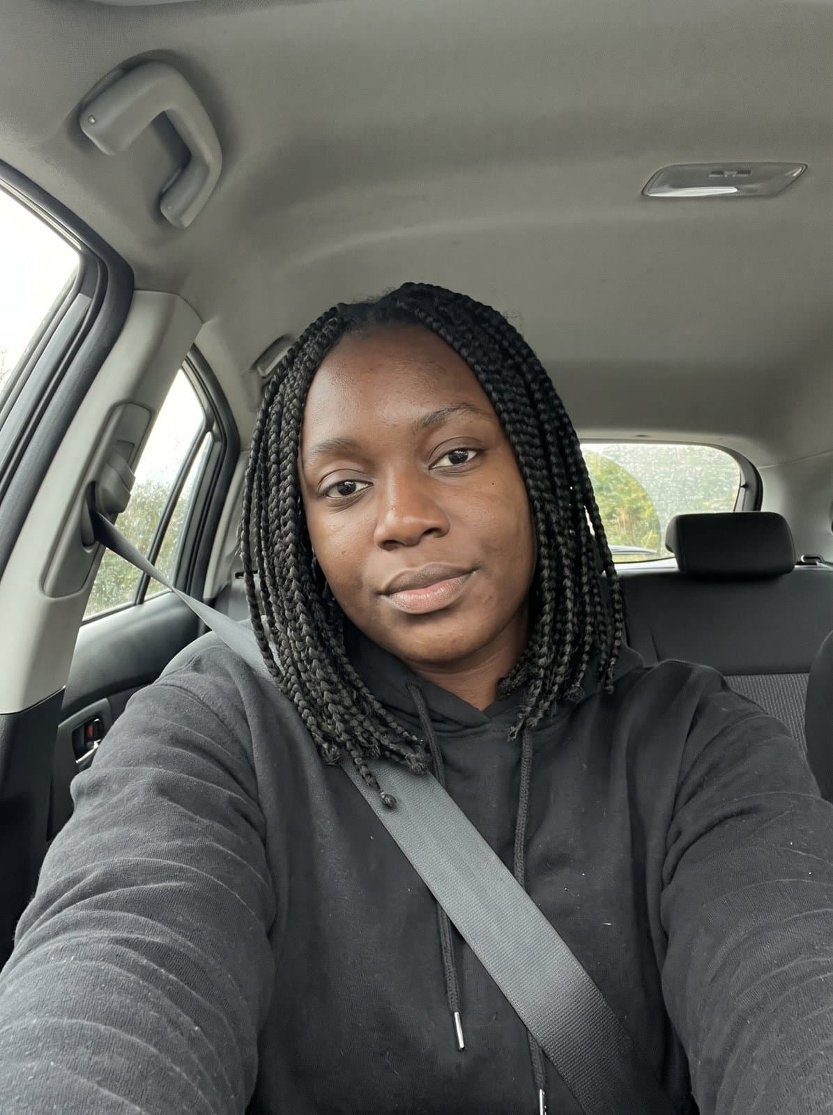 Invented person: AI-generated example input, selfie in a parked car